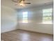 Sunny bedroom with hardwood flooring, ample natural light, and a ceiling fan at 196 Golfview Ave, Benson, NC 27504