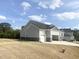 Side view of a well-maintained home featuring a three-car garage on a spacious lot with a fire hydrant at 196 Golfview Ave, Benson, NC 27504
