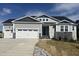 Charming home featuring a three-car garage, stone accents, and attractive gray siding under a blue sky at 196 Golfview Ave, Benson, NC 27504
