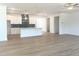 Open-concept kitchen with hardwood flooring, white cabinetry, and stainless steel appliances, perfect for entertaining at 196 Golfview Ave, Benson, NC 27504