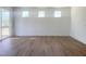 Bright and spacious living room with hardwood flooring and three windows offering plenty of natural light at 196 Golfview Ave, Benson, NC 27504