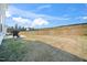 Spacious back yard featuring a patio, grill and retaining wall offering ample space for outdoor activities at 196 River Bank Rd, Fuquay Varina, NC 27526