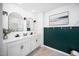 Modern bathroom featuring double sink vanity with framed mirrors, and a green accent wall at 196 River Bank Rd, Fuquay Varina, NC 27526