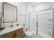 Bathroom with tiled walk-in shower, modern vanity, and a stylish mirror at 196 River Bank Rd, Fuquay Varina, NC 27526
