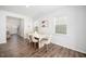 Elegant dining room with wood floors, a modern table, and abundant natural light at 196 River Bank Rd, Fuquay Varina, NC 27526
