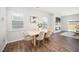 Bright dining room with wood floors, neutral colors, and a large window at 196 River Bank Rd, Fuquay Varina, NC 27526