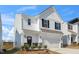 Charming two-story home with white siding, black shutters, and a spacious two-car garage at 196 River Bank Rd, Fuquay Varina, NC 27526