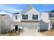 Charming two-story home with white siding, black shutters, and a spacious two-car garage at 196 River Bank Rd, Fuquay Varina, NC 27526