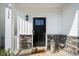 Inviting front porch with a black door, stone accents, and a charming lantern at 196 River Bank Rd, Fuquay Varina, NC 27526