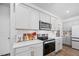 Bright kitchen featuring white cabinets, subway tile backsplash, and stainless steel appliances at 196 River Bank Rd, Fuquay Varina, NC 27526