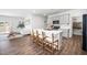 Bright kitchen with a large island, seating, and a view into the living room at 196 River Bank Rd, Fuquay Varina, NC 27526