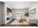 Modern living room featuring a fireplace, wood flooring, and a cozy seating area at 196 River Bank Rd, Fuquay Varina, NC 27526
