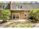 Brick home featuring a back patio with a sliding glass door and trimmed hedges at 2 Banbury Ln # 2, Chapel Hill, NC 27517