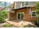 Brick home featuring a back patio with a sliding glass door and trimmed hedges at 2 Banbury Ln # 2, Chapel Hill, NC 27517