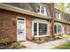 Attractive brick home with bay window, complemented by a well-maintained walkway and lush landscaping at 2 Banbury Ln # 2, Chapel Hill, NC 27517