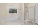 Bright bathroom with a tub, shower, and natural light at 211 Richmond Run, Stem, NC 27581