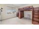 Nicely carpeted bedroom featuring bunk beds, dresser, and ample natural light at 211 Richmond Run, Stem, NC 27581