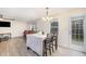 Open-concept dining area with laminate flooring, a chandelier, and a doorway to the back at 211 Richmond Run, Stem, NC 27581
