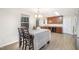 Bright dining area with laminate flooring, a view to the kitchen and a backyard view at 211 Richmond Run, Stem, NC 27581