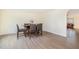 Bright dining room featuring laminate flooring and a dining table with seating for six at 211 Richmond Run, Stem, NC 27581