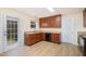 Well-lit kitchen features stainless steel appliances, wood cabinets, and access to a patio at 211 Richmond Run, Stem, NC 27581