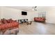 Cozy living room featuring laminate flooring, comfortable seating, and a ceiling fan at 211 Richmond Run, Stem, NC 27581