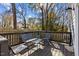 Inviting back deck featuring a glass top table, comfortable seating, and a wooden fence for privacy at 2207 Otis St # A, Durham, NC 27707