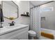Bathroom featuring white vanity, tub and shower with patterned curtain at 2207 Otis St # A, Durham, NC 27707