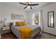 Comfortable bedroom featuring a queen-sized bed, ceiling fan, and natural light from the window at 2207 Otis St # A, Durham, NC 27707
