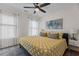 Cozy bedroom featuring a king-sized bed, ceiling fan, and large windows with patterned curtains at 2207 Otis St # A, Durham, NC 27707
