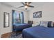 Bedroom with two blue beds, ceiling fan and art hanging on the wall at 2207 Otis St # A, Durham, NC 27707