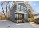 Charming gray two-story home with a bright yellow front door, covered porch, and freshly poured concrete driveway at 2207 Otis St # A, Durham, NC 27707
