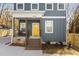 Beautiful exterior of the home featuring a bright yellow front door and covered porch with wrought iron railings at 2207 Otis St # A, Durham, NC 27707