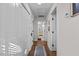 Hallway with multiple closets and doorway to a bathroom with orange accents at 2207 Otis St # A, Durham, NC 27707