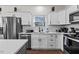 Kitchen with white cabinets, stainless steel appliances, and sleek countertops, offering a modern cooking space at 2207 Otis St # A, Durham, NC 27707