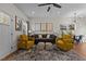 Stylish living room with hardwood floors, a ceiling fan, and two plush yellow armchairs at 2207 Otis St # A, Durham, NC 27707