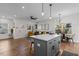 Open-concept space showcasing the kitchen and living room with hardwood floors, lots of light, and a modern aesthetic at 2207 Otis St # A, Durham, NC 27707