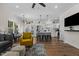 Open-concept living room and kitchen with hardwood floors, modern lighting, and stainless steel appliances at 2207 Otis St # A, Durham, NC 27707