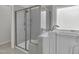 Modern bathroom featuring a glass-enclosed shower and tub at 233 Stone River Dr, Wendell, NC 27591