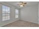 Bedroom with neutral carpeting and natural light from two large windows at 233 Stone River Dr, Wendell, NC 27591