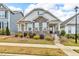 Charming home featuring stone accents, manicured landscaping, and a welcoming front porch at 233 Stone River Dr, Wendell, NC 27591