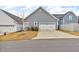 A house with a two-car garage and ample parking space on the driveway at 233 Stone River Dr, Wendell, NC 27591