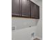 Laundry room with overhead cabinets and utility connections at 233 Stone River Dr, Wendell, NC 27591