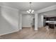 Inviting living space with neutral walls, wood-look flooring and open floor plan to the kitchen at 233 Stone River Dr, Wendell, NC 27591