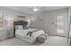 This bedroom features a queen bed, side tables, and a door to the exterior at 2629 Sweetgum Dr, Apex, NC 27539