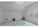 Large bonus room offering versatility with neutral carpet and natural light from the windows at 2629 Sweetgum Dr, Apex, NC 27539