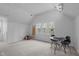Bright bonus room with a window, a table, and comfortable chairs for games or leisure at 2629 Sweetgum Dr, Apex, NC 27539
