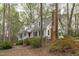 Charming two-story home with white siding, black shutters, red door, and mature landscaping at 2629 Sweetgum Dr, Apex, NC 27539