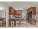 This eat-in kitchen features wood cabinets, stainless appliances, and bar stool seating at 2629 Sweetgum Dr, Apex, NC 27539