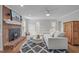 Inviting living room with a brick fireplace and large windows, offering ample natural light at 2629 Sweetgum Dr, Apex, NC 27539